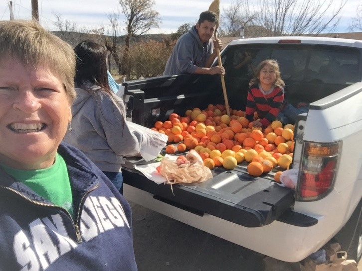 Me, Carmello, Mike and JoJo bagging oranges.